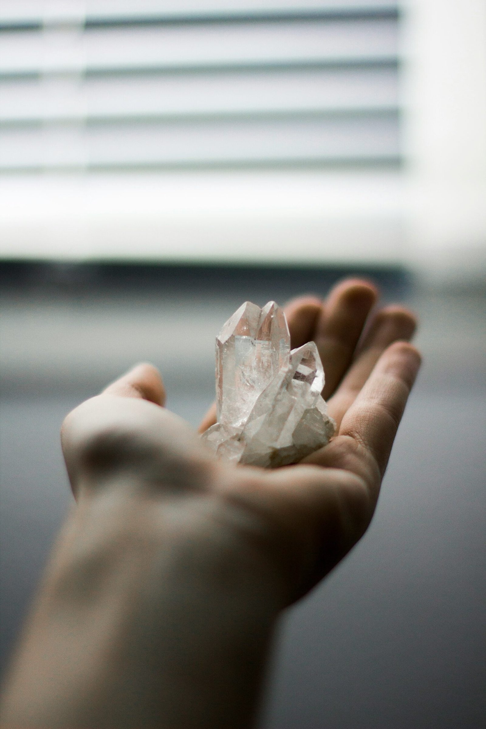 person holding crystal stones